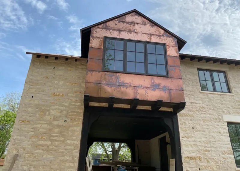 Copper metal panel facade on a stone building for Skylight Installation in Sutherlin